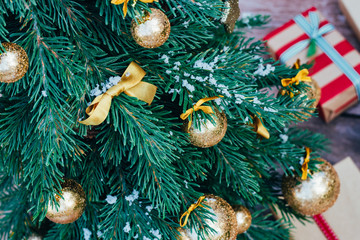 Christmas background. Green fir tree with golden balls and gift boxes. - 300312528