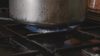 igniting a flame under a pan