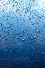 Ice on water surface in early winter.