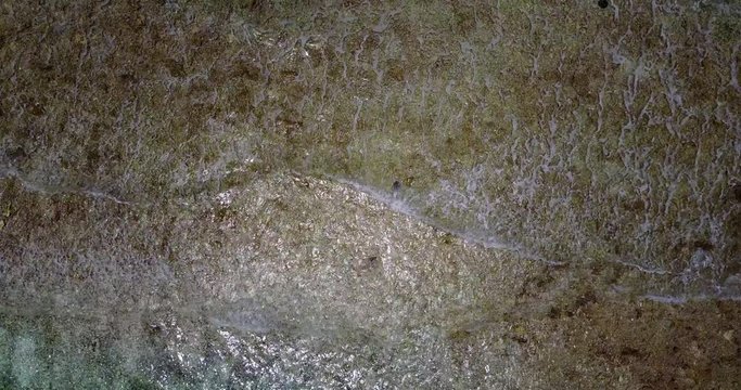 Exotic waves on baech in Bahamas, top-down of water in surf on a beach, relaxing background