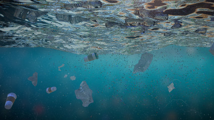 plastic pollution in ocean water, bottles floating in the current  © dottedyeti