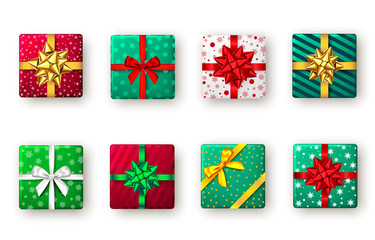 Gift box with green, red, golden ribbon and bow, top view.