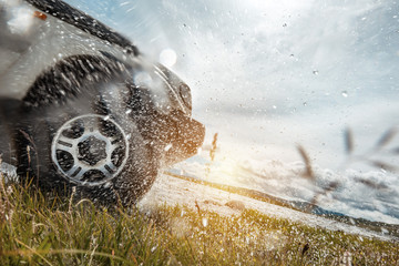 4x4 car wheel and water splashes © cppzone