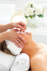 Oxygen oxybrasion. The beautician performs oxygen oxybrasion treatment on the skin of a woman's...
