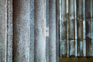 Fototapeta premium Fragment of antique columns background. Selective focus.