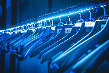 hangers hangers for clothes illuminated with neon tape hanging in a row