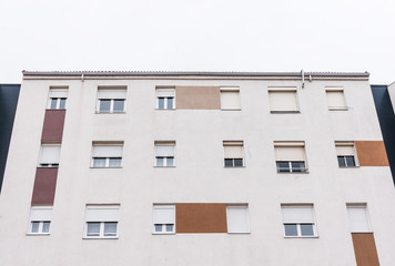 Fototapeta premium white facade with windows in residential building