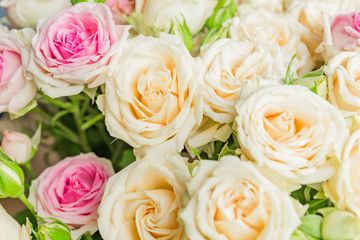 A big group of pink and white  roses in a wedding decoration