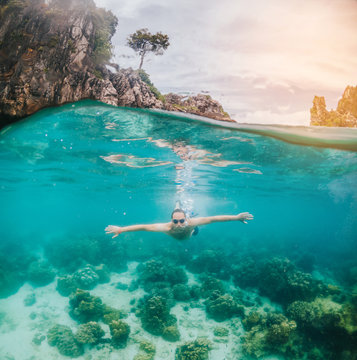 Split-view image of a swimmer enjoying clear water on tropical island. Summer lifestyle concept. 