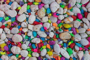 background of colorful, polished, semiprecious stone on grained wood