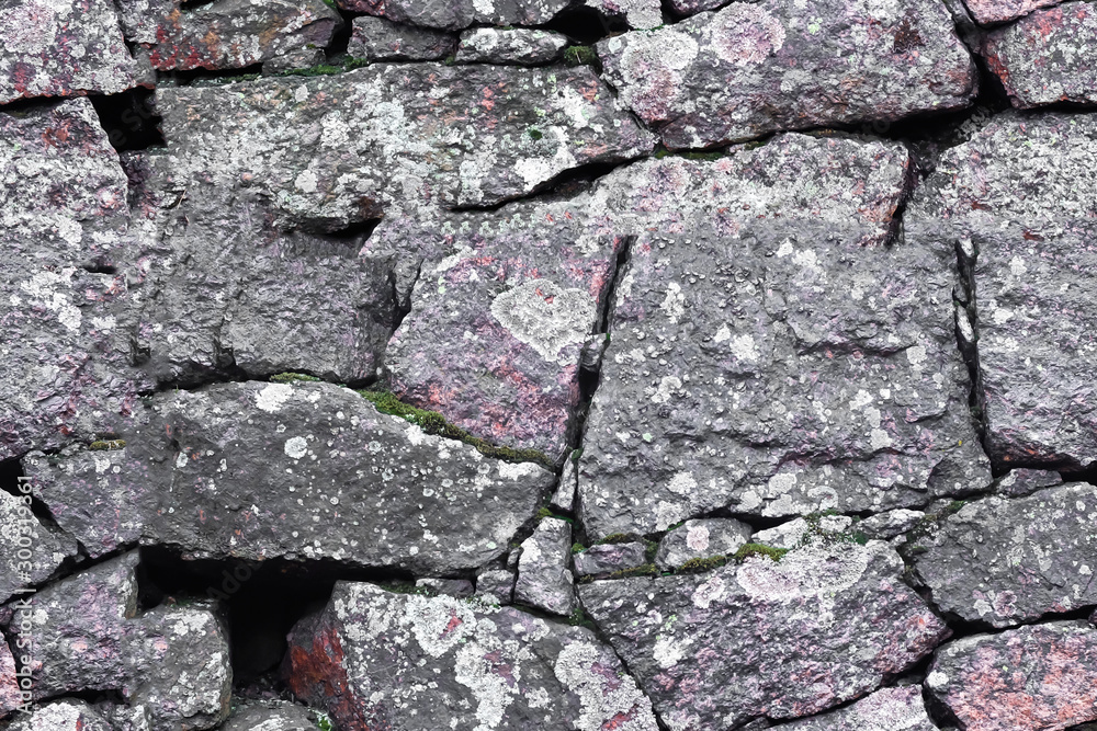 Wall mural seamless texture. stone wall made of boulders of granite.