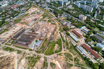 Demolition work of a large old factory. Dismantling on the territory of a big city. aerial view