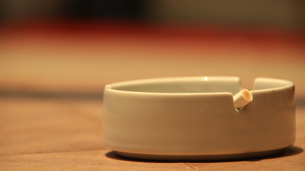 cigarette ashtray on the table, in a photo with a blurry background and selective focus