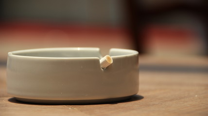 cigarette ashtray on the table, in a photo with a blurry background and selective focus