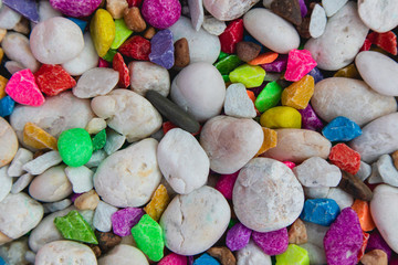 background of colorful, polished, semiprecious stone on grained wood