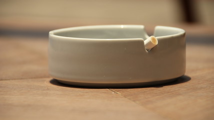 cigarette ashtray on the table, in a photo with a blurry background and selective focus