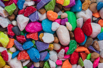 background of colorful, polished, semiprecious stone on grained wood