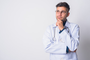 Portrait of young Persian man doctor thinking - 300320765