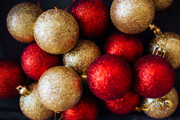 Red and golden Christmas balls decoration top view. New year greeting card. Festive backdrop.