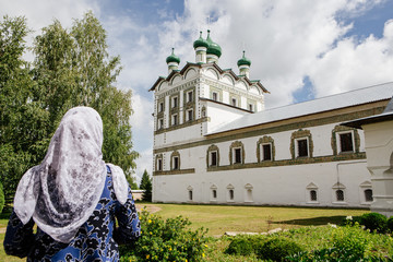 Orthodox woman in front of Vyazhishchskii Monastery. Novgorod