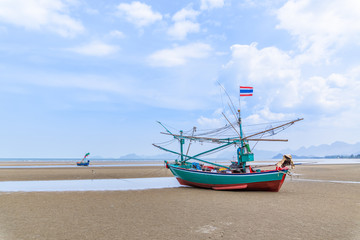 Fototapeta na wymiar Fishing boat on beach near fisherman village at Khao Kalok mountain, near Hua Hin, Thailand