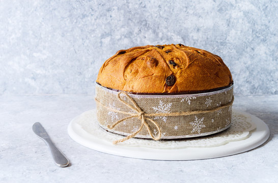 Panettone, typical christmas italian food, on rustic background.