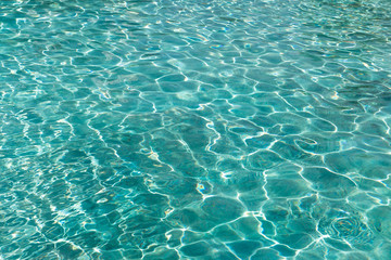 Naklejka na ściany i meble Turquoise blue water in swimming pool background, sun reflection, clear clean water, shining water ripple background, Aqua texture, pattern