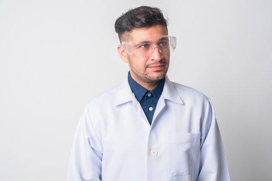Face of young Persian man doctor as scientist thinking
