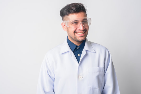 Face of happy Persian man doctor as scientist thinking