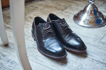 Shoes on a floor. Different accessories of  businessman for creating  style of people lie on wooden background