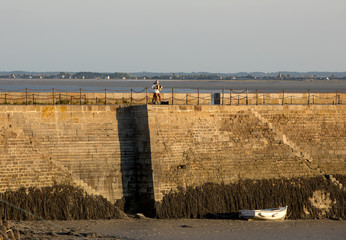 Accordionist on the breakwater in Cancale, Brittany, France