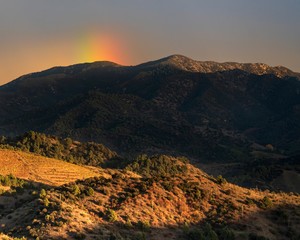 Rainbow burst in Escaladei mountains
