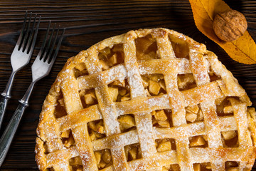 Homemade American Apple Pie Decorated with fresh apples and autumn leaves