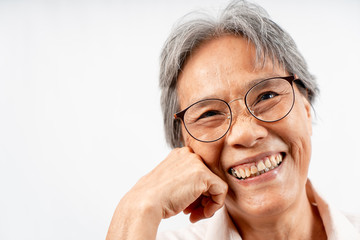 Asian  senior woman smiling with hand touching chin studio shot isolated on white background