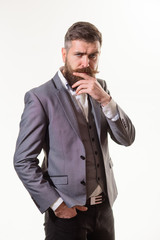 Pondering businessman. Pensive smart successful bearded businessman in elegant suit pondering business strategy. Thoughtful dreamy serious man. Attractive bearded man in suit thinking about something.