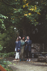 Three stylish young women in fashion clothes.