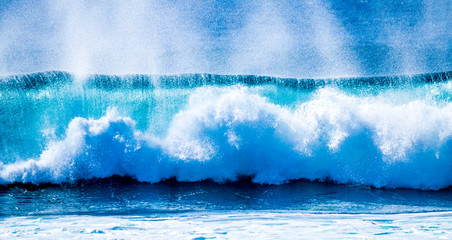 close up of beautiful and bigs blue and green waves breaking - pacific or athlantic ocean - blue sea and great place to surf