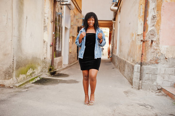 Stylish trendy afro france curly woman posed at autumn day in jeans jacket. Black african female...