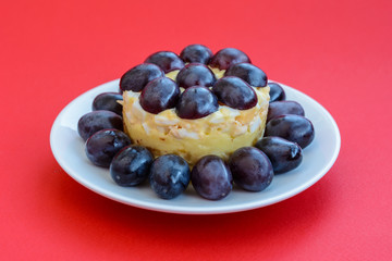The legendary Tiffany layered salad with grapes, chicken and cheese on the red background.