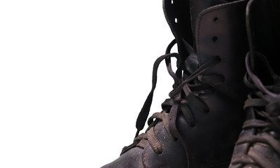 Old worn laced boots isolated on a white background