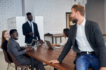 Multi-ethnic group of business partners gathered together to discuss new business projects related...