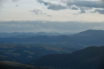 snow-capped peaks of the mountains. clouds walking in the evenings over the mountains