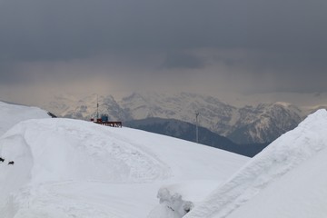 Snowdrifts and snow-capped peaks with different lighting in the Caucasus mountains