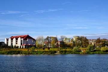 Obraz premium Balaton Lake in Warsaw, Poland. Park and water reservoir located in Warsaw city. View on the Church of Apostles John and Paul. Panoramic view