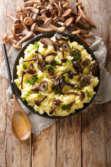 Roasted honey mushrooms with mashed potatoes close-up in a plate with ingredients. Vertical top view