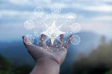 Technology, hand holding with environment Icons over the Network connection on green background