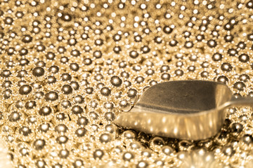 lot of golden sweets with a spatula