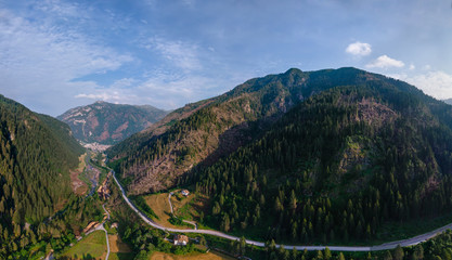 Aerial view of mountain road, mountains and a river near the town of Predazzo, Trentino, Italy consequences of bad weather, windbreak, broken trees in the mountains damage to nature and tourism