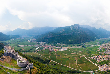 Aerial view of Beseno Castle and northern vineyards, the largest fortified structure in Besenello, Trento, Italy. wide panorama with high resolution, touristic place in Europe