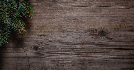 Christmas green frame from fir branches on a vintage gray board background. Frame of fir branches. Christmas card blank.